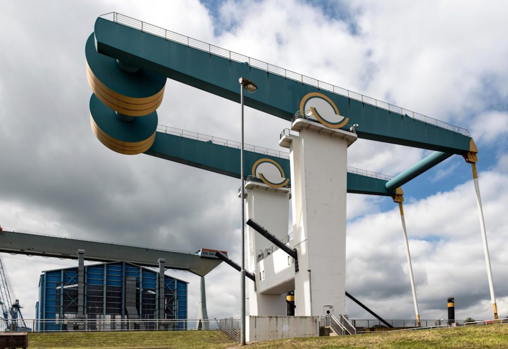 a tall white and green structure with a sky background
